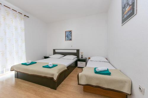 a bedroom with two beds and a window at Apartment Gradac 14708b in Gradac