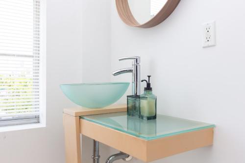 a bathroom counter with a sink and a glass bowl at Home Miami Downtown with Balcony - 5 minutes from Wynwood & Port - Art District near Beach in Miami