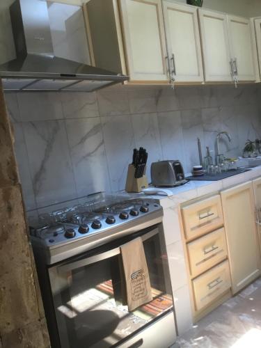 a kitchen with an oven with a box in it at La Casa de Ensueño in Guadalajara