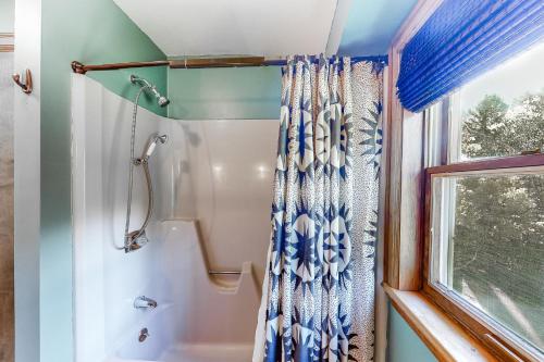 a bathroom with a shower and a shower curtain at Pittsfield Paradise in Pittsfield