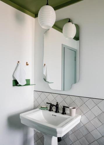 a bathroom with a sink and a mirror at Daunts Albatross Motel in Montauk