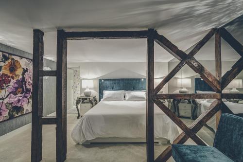 a bedroom with a large bed with a wooden frame at Deco Gem Bica in Lisbon