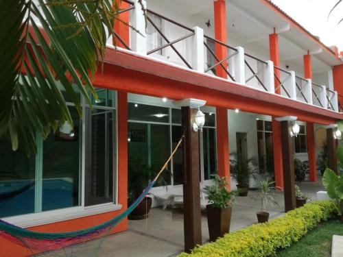 a building with a hammock outside of it at quintaolivos Jardín y Alberca! in Alpuyeca