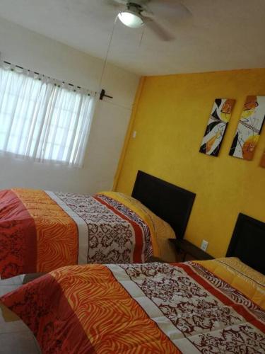 a room with three beds in a room at quintaolivos Jardín y Alberca! in Alpuyeca