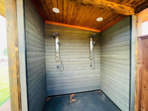 a shower stall in a house with a wooden ceiling at Desert Sage Retreat in Colorado City