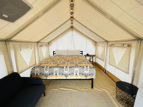 a bedroom in a tent with a bed in it at Desert Sage Retreat in Colorado City