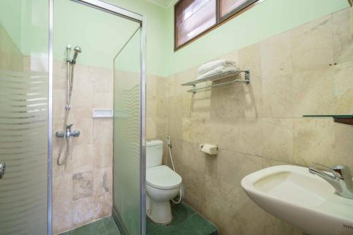 a bathroom with a toilet and a sink and a shower at RedDoorz Plus near Kemang Raya in Jakarta