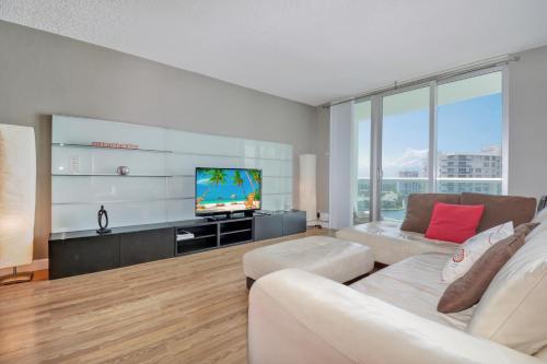 a living room with a white couch and a tv at THE TIDES 1bedroom apt 15th floor WE ARE ON THE BEACH! in Hollywood