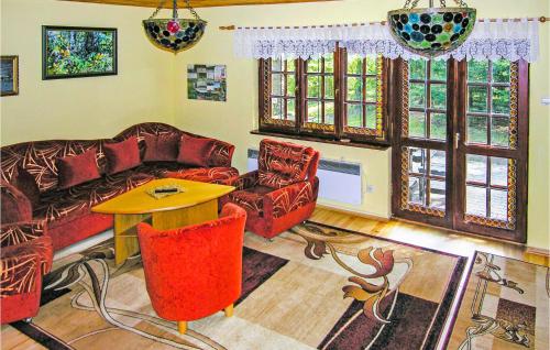 a living room with a couch and chairs and a table at 3 Bedroom Stunning Home In Grunwald in Mielno