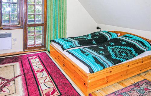 a bedroom with a bed in a room with a rug at Nice Home In Grunwald With 3 Bedrooms And Wifi in Mielno