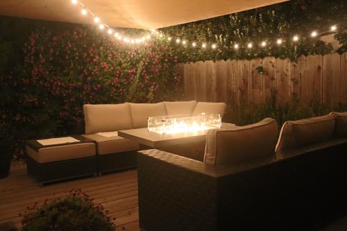 a patio with a couch and a table and lights at Casa Esperanza. Peaceful Get Away W/Hot tub. in Salinas