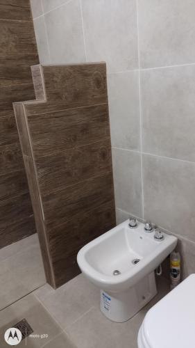 a bathroom with a white sink and a toilet at Valle Encantado in Monte Hermoso