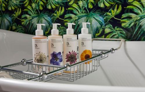 a wire basket with four bottles of lotion at Hotel Indigo - Exeter by IHG in Exeter