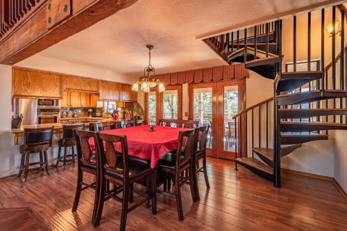 a kitchen and dining room with a red table and chairs at Mountain View Playhouse Near Yosemite & Bass Lake in Oakhurst
