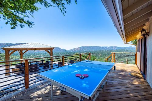 a ping pong table on the deck of a house at Mountain View Playhouse Near Yosemite & Bass Lake in Oakhurst