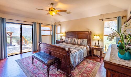 a bedroom with a bed and a ceiling fan at Mountain View Playhouse Near Yosemite & Bass Lake in Oakhurst