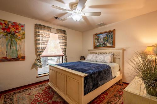 a bedroom with a bed and a ceiling fan at Mountain View Playhouse Near Yosemite & Bass Lake in Oakhurst