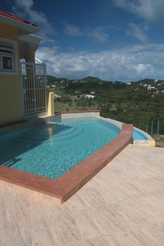 a swimming pool on the side of a house at South Sea House in Cap Estate