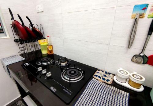a kitchen with a stove top oven in a kitchen at D'Luna Homestay Melaka Fully Aircond in Melaka