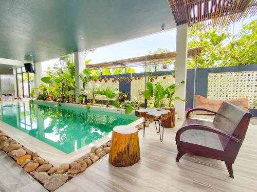 a swimming pool in a house with plants at Nha Bong Villa in Hoi An