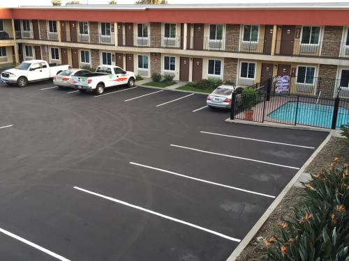 a parking lot in front of a building at Ontario Inn & Suites in Montclair