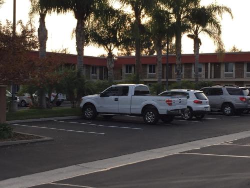 a white pickup truck parked in a parking lot at Ontario Inn & Suites in Montclair