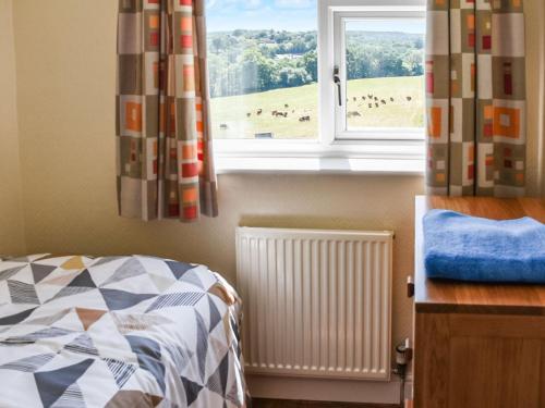 a bedroom with a bed and a window at Valley View in Upper Arley