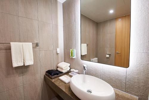 a bathroom with a sink and a mirror at Busan City Hotel in Busan