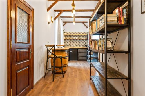 a room with wooden floors and shelves with books at Villa Libosad in Jičín