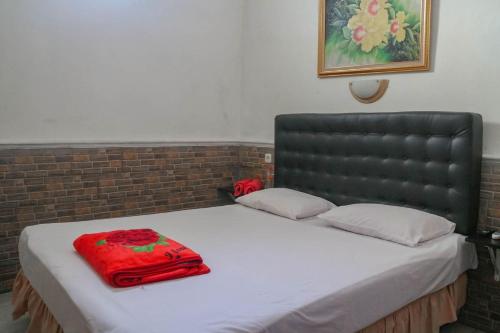 Postel nebo postele na pokoji v ubytování Wisma Vandera Syariah Garut Mitra RedDoorz