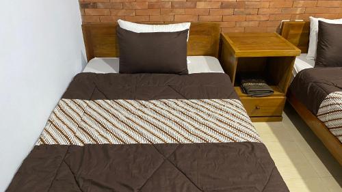Postel nebo postele na pokoji v ubytování Homestay Candi Pawon Murtakim Syariah
