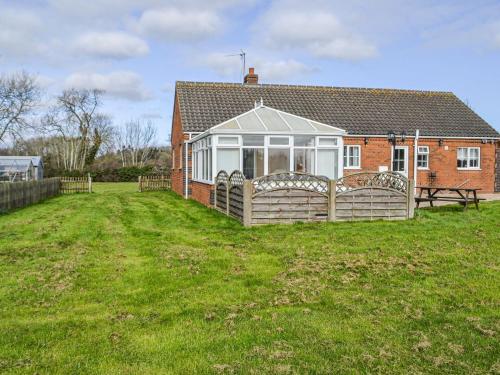 a house with a fence around a yard at Holmfield in Willoughby