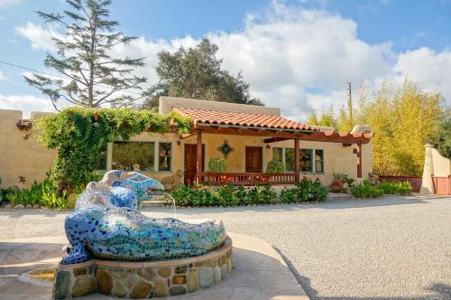 a house with a statue in front of a house at Blue Iguana Inn in Ojai