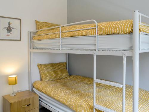 two bunk beds in a small room with a bed at Greentops in Blackwood