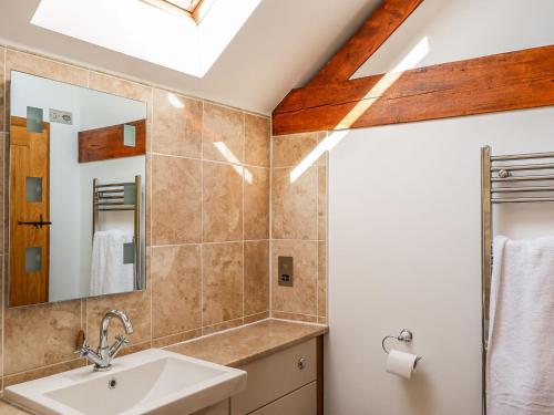 a bathroom with a sink and a mirror at The Milking Parlour in Tutbury