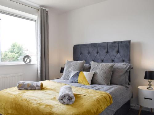 a bedroom with a large bed with a large window at Carr Naze House in Filey