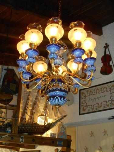 a chandelier with blue and white vases hanging from a ceiling at Chateaux Constantin Agistro in Ángistron