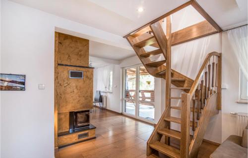 una scala in legno in un soggiorno con camino di 4 Bedroom Nice Home In Huta Wielka a Huta Wielka
