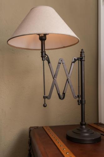 a lamp sitting on top of a wooden table at Hôtel des Palmistes in Cayenne