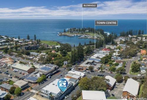 an aerial view of a town centre with the ocean at 2 bedroom modern coastal retreat in Kiama