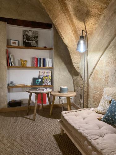 a living room with a couch and a table at L'Aiguillerie in Montpellier