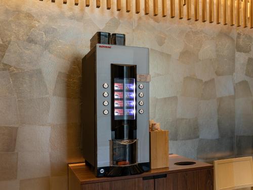 a coffee machine sitting on top of a wooden table at Best Western Hotel Fino Tokyo Akihabara in Tokyo