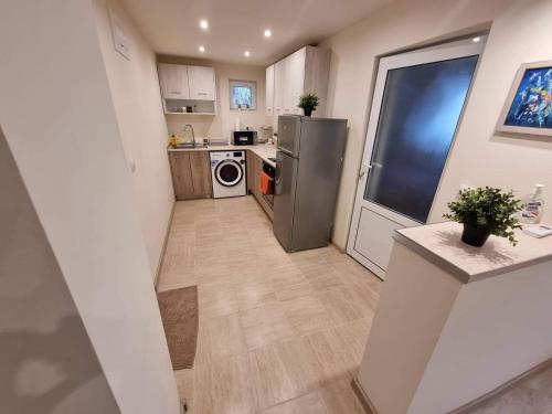 a small kitchen with a stainless steel refrigerator at Guest House 59 in Varna City