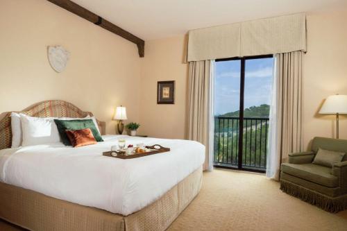 a bedroom with a large bed and a balcony at Hotel Viata in Austin