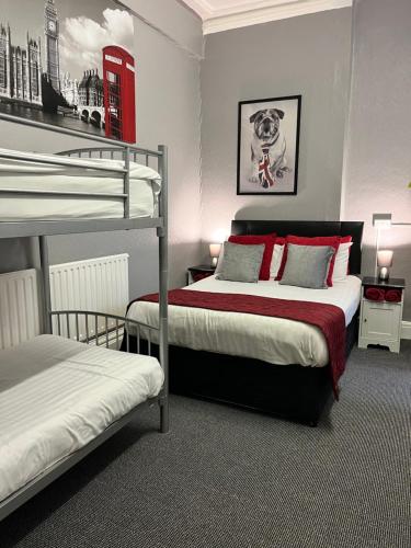 a bedroom with two bunk beds and a dog on a poster at On The Beach Apartments in Blackpool