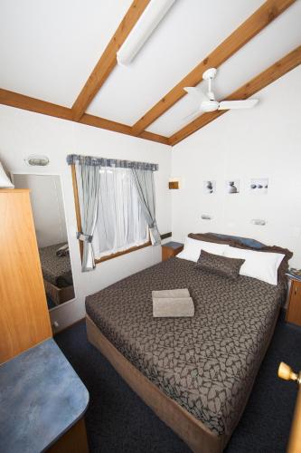 a bedroom with a large bed in a room at BIG4 Robe Lakeside Tourist Park in Robe