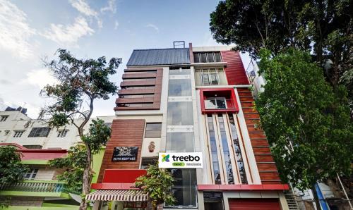 a tall building with a sign in front of it at Treebo Trend Elite Heritage in Bangalore