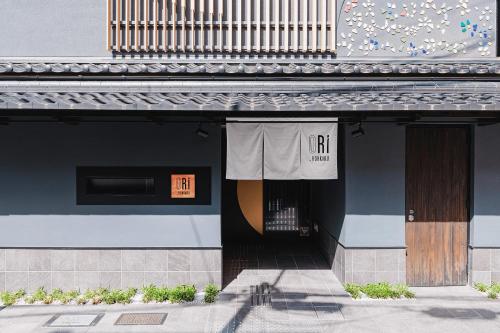 una puerta delantera de un edificio con un cartel en ORI Rokkaku en Kyoto