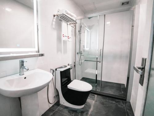 a bathroom with a toilet and a sink and a shower at Gateway To Kota Samarahan education hub Sama Jaya ind centre classic 30BR by Natol Traveller & Business Inn in Kuching