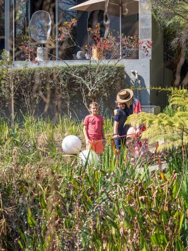 two children standing in the grass in a garden at Seven Villa Hotel & Spa in Johannesburg